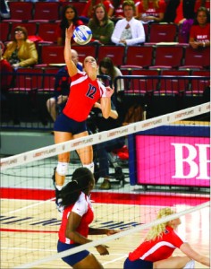 Spike — Lillie Happel (12) attempts to deliver a deciding blow in a 3-0 victory against Coastal Carolina.  Photo credit: Courtney Russo