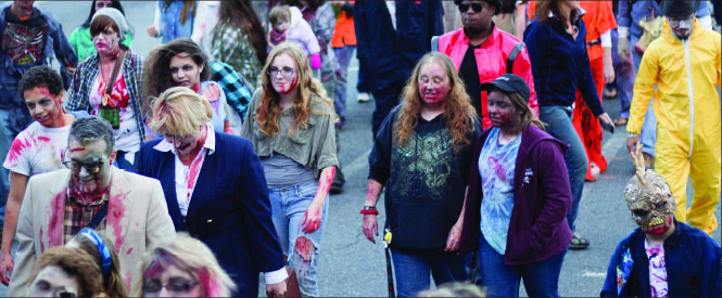 Slow and Steady —The Zombie Walk brought a large crowd and also featured a brain-eating contest, costume prizes, makeup artists and more. Photo credit: Leah Stauffer
