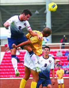 USe YOUR HEAD — Sam Dunnick (2) heads the ball upfield against Winthrop. Photo credit: Ruth Bibby