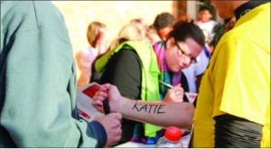 Motivation — Participants have the option of having a victim’s name written on them. Photo credit: Sara Warrender