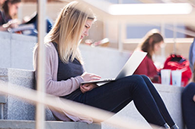 student reading on campus