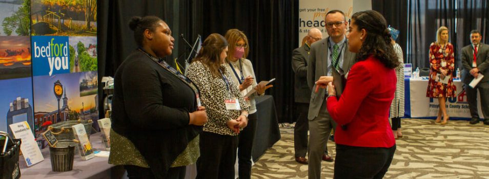 A student talking to an employer by their stand