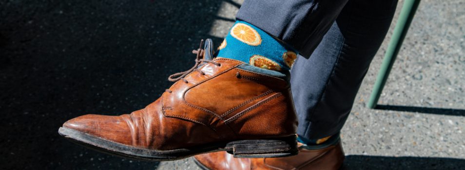 Male dress shoes and orange fruit socks