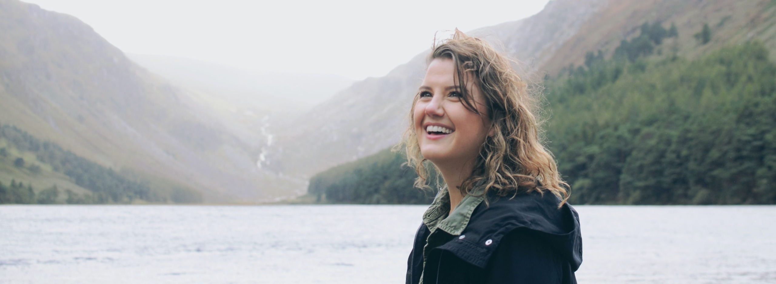 woman smiling outside by the water