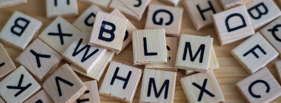 brown wooden scrabble blocks with letters