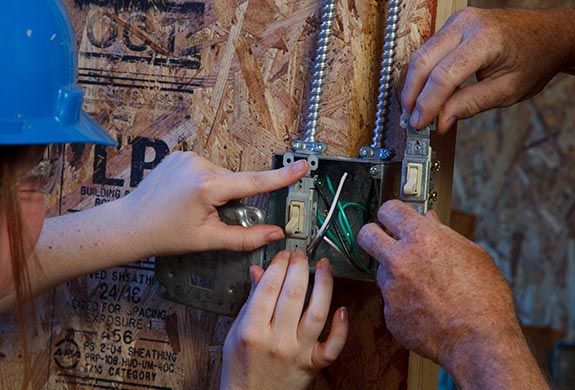 Students wiring light switches