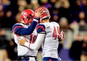 Celebrate — Javan Shashaty (18) and John Lunsford (49) had plenty of reasons to be happy, each playing key roles in the Flames 26-21 playoff victory over James Madison.  Photo credit: Joel coleman