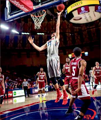 Maxin’ — Flames center Evan Maxwell lays it in during the win against Winthrop. Photo credit: Leah Seavers