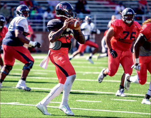 poised — Flames quarterback Stephon Masha drops back to pass in the annual spring football game Saturday. Photo credit: Michela Diddle
