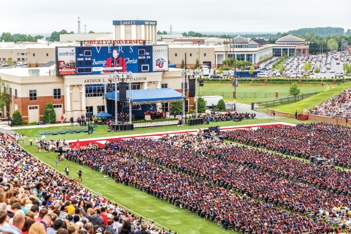 STADIUM — President Jerry Falwell opened the 2015 commencement ceremony before former Florida Gov. Jeb Bush addressed the crowd of graduates. Photo credit: James Hancock