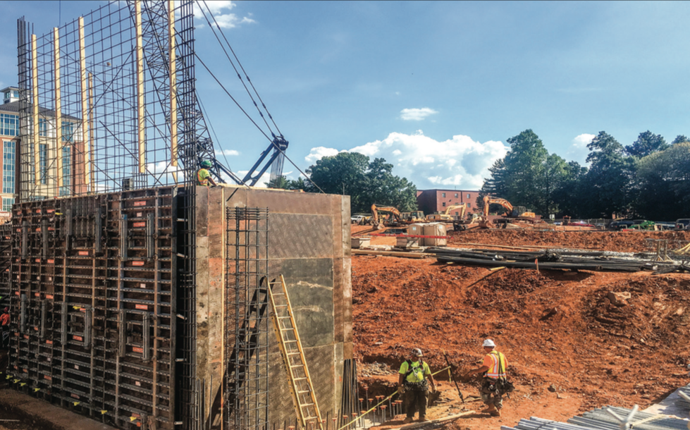 CAMPUS ADDITION — A construction crew worked on the new dorm building. Photo credit: Jonathan husker