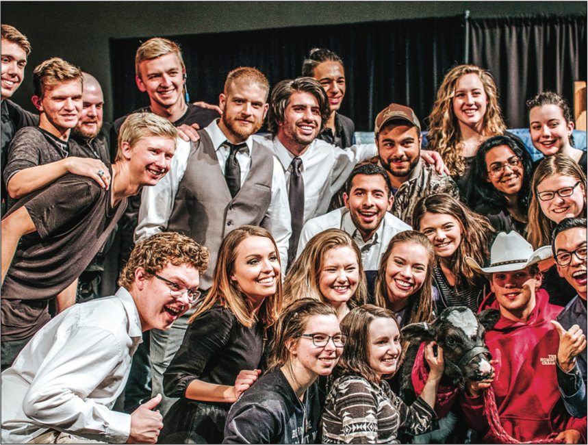 CREW AND A COW — The cast and staff posed with Cur e the cow a week before the show aired. Photo Credit: Jared Powell