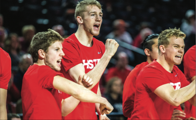 EXCITED — Flames forward Ezra Talbert (center) has played in 26 games for the Flames this season. Photo Credit: Michela Diddle