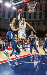 DUNK — Senior guard John Dawson went airborne. Photo Credit: Amber Tiller 