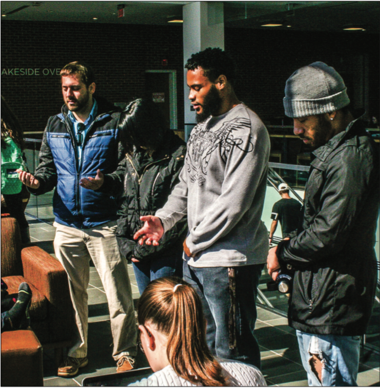 AMEN — Members from Standing with God Ministries prayed over students in the library. Photo Credit : RyLie Rice