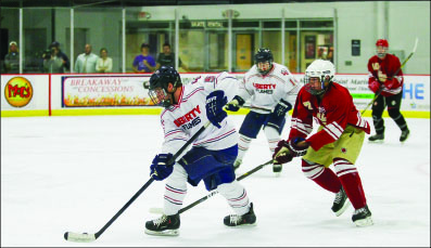 smooth transition — Freshman defenseman Ryan Sidun handles the puck against Elon. Photo credit: Ruth Bibby