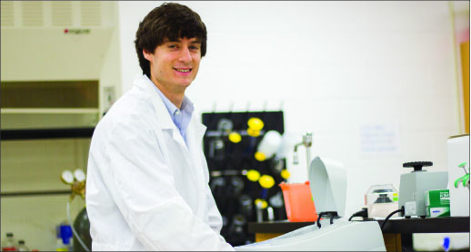 science — Davy works on an experiment in the lab where he has spent much of his college career. Photo credit: Sam Chappell