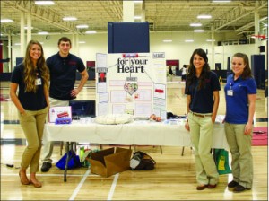 exercise — The basketball courts were filled with booths that focused on well being. Photo credit: Abby Kourkounakis