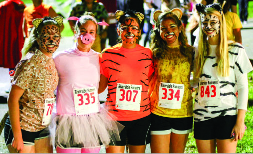 Masks — Students show off their costumes for the Halloween Fun Run at Camp Hydaway. Photo credit: Courtney Russo
