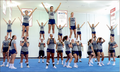 passion— Cheerleaders have practiced for hours each day to prepare to support the Flames football team. Photo credit: Leah Seavers