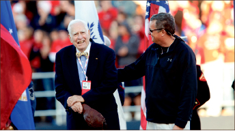 Family — George Rogers (left) stands with his son Jeff during a ceremony at Liberty University, which honored him with a statue placed at Williams Stadium. Photo credit: Les Schofer