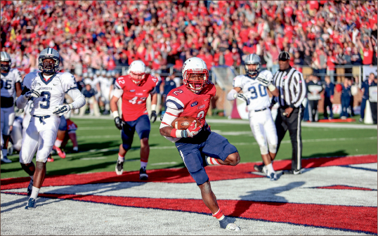Big Night— Running back D.J. Abnar powers past the Monmouth defense for his first of two touchdowns against the Hawks. Photo credit: Leah Seavers