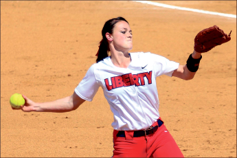The windup— Sophomore pitcher Kenzie Friesen delivers a pitch against Coastal. Photo credit: Courtney Russo
