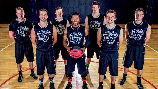 a team effort — Chandler Bronkema (far right), along with the rest of the S.O.A.R. Dunk team, ministers through basketball. Photo credit: David Duncan