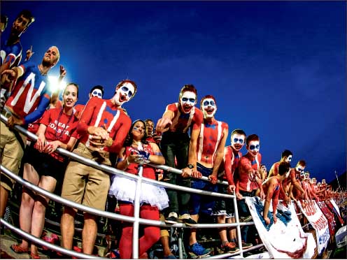 spirited — Jerry’s Jokers face paint includes a white base with a stretched red smile and a dark blue coat around the eyes. Photo credit: Leah Seavers