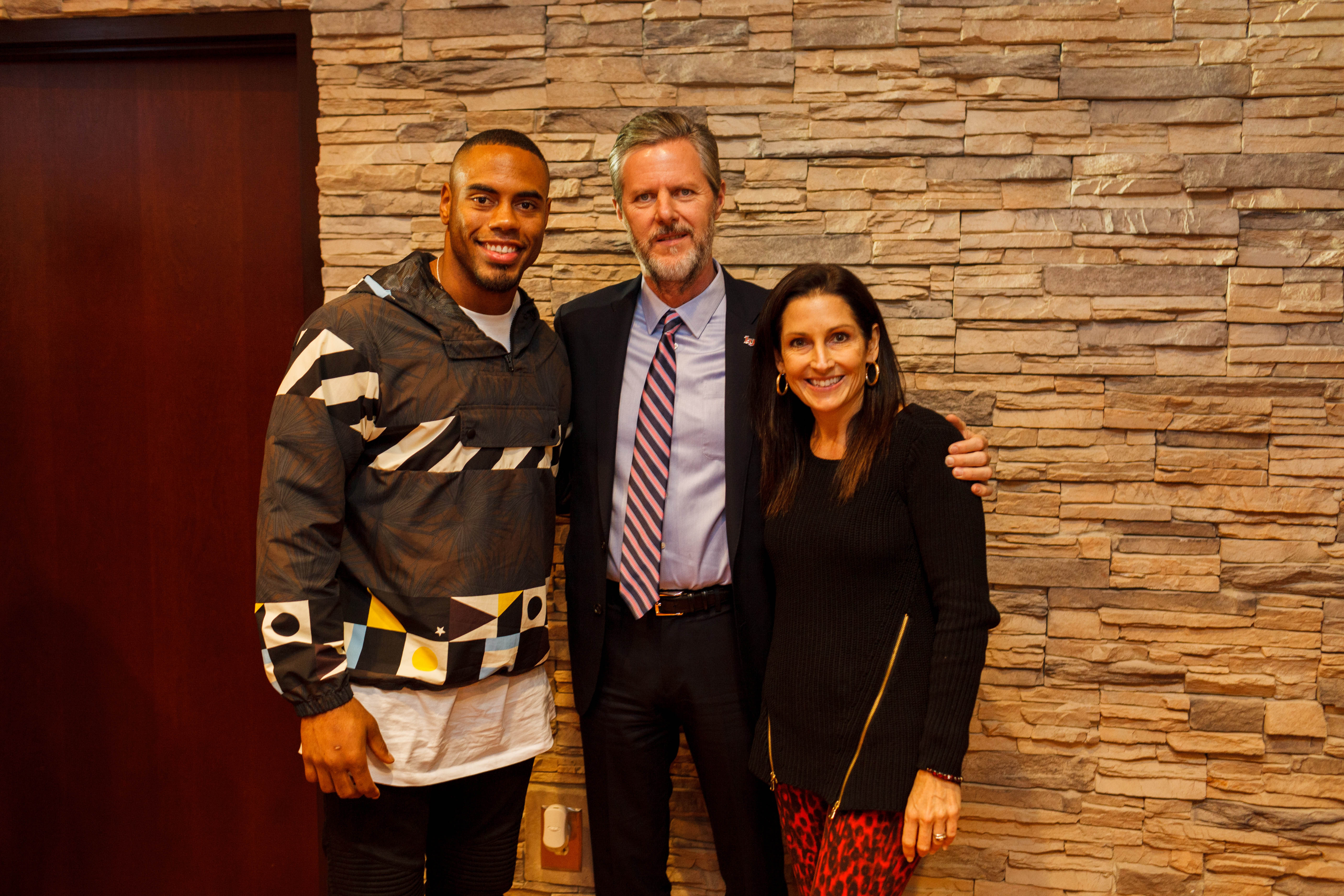 Rashad Jennings enjoyed watching the Coastal Carolina game with Jerry and Becki Falwell Nov. 19, 2015." Credit: Joel Coleman | Liberty University News Service