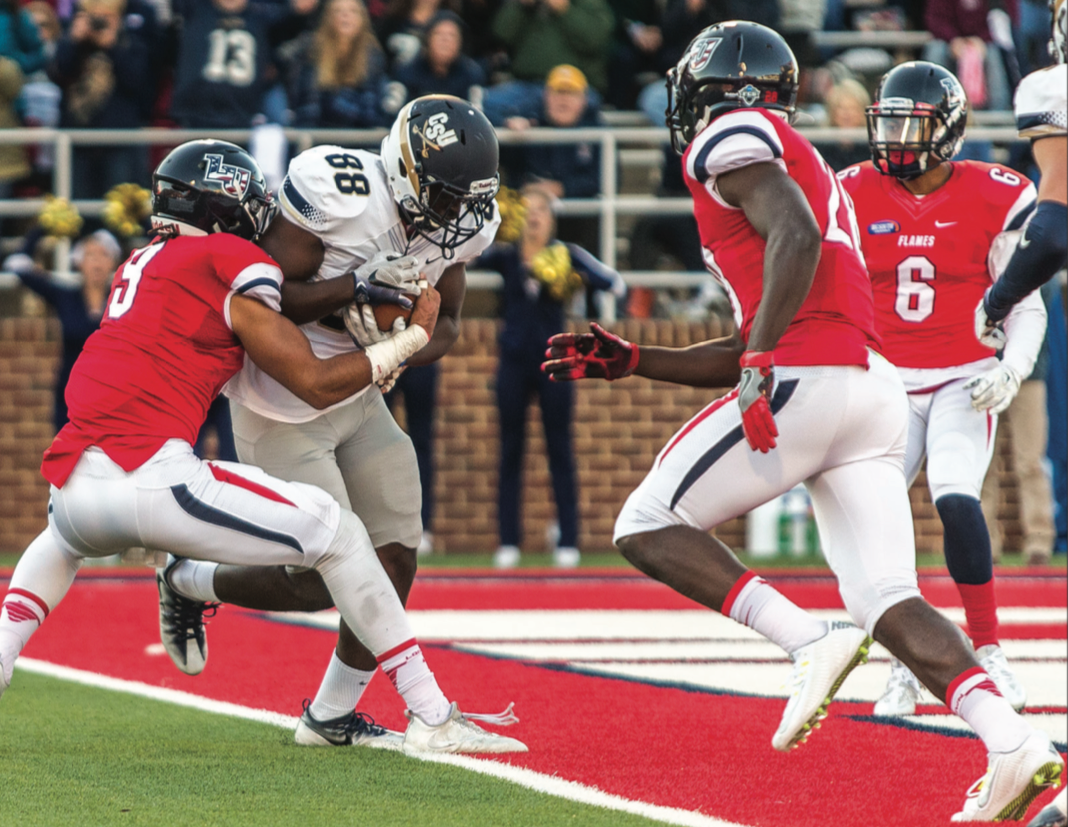 SCORE — Bucs tight end Travay Hatten plowed past Flames senior linebacker Nate Newman for the game’s first touchdown. Photo credit: Michela Diddle