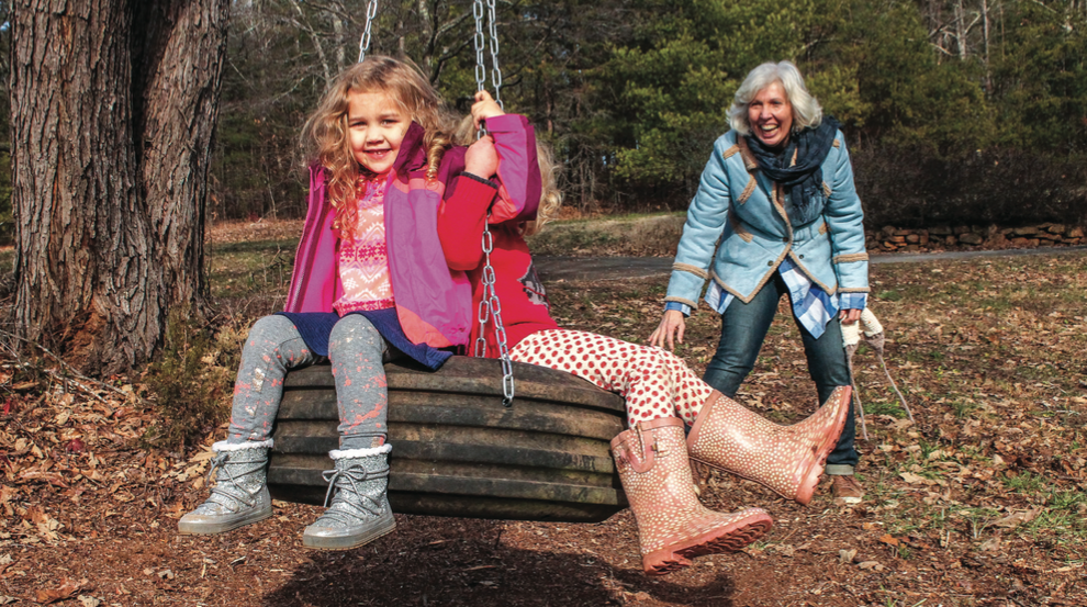 ENJOYING FAMILY — Debbie Perdew pushed two of her granddaughters on one of the tree farm’s three tire swings. Photo credit: Amber Tiller