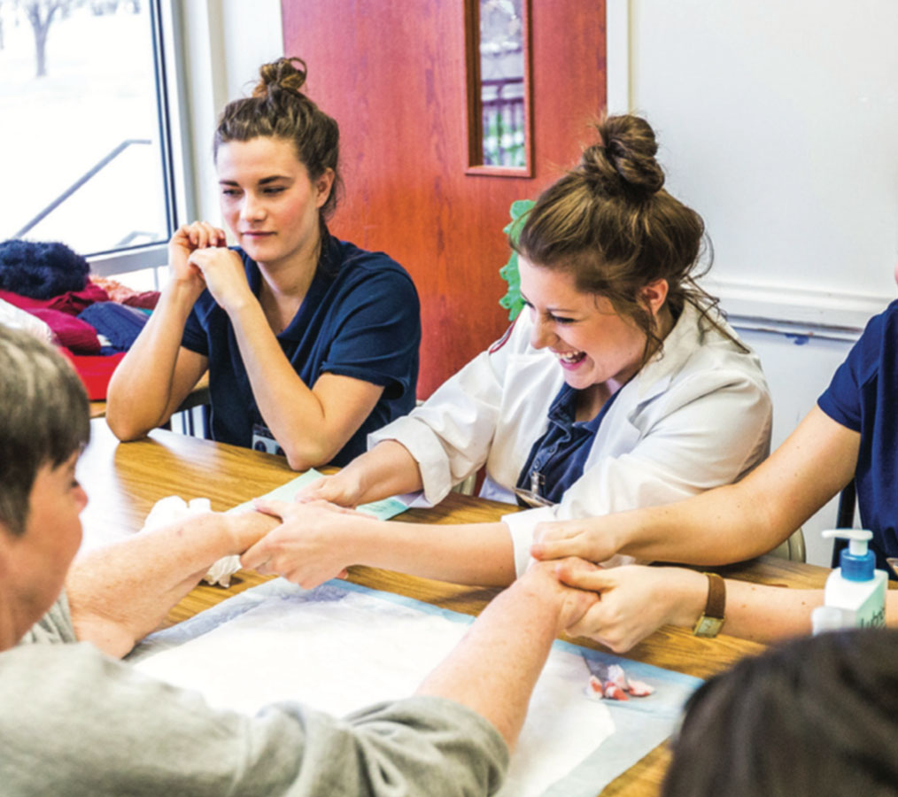 ENCOURAGE — Sophomore nursing students served shelter residents with free pampering Photo Credit: Kaitlyn BecKer Johnson