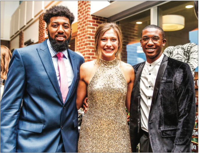 AWARDS — Basketball players A.C. Reid (left) and Lovell Cabbil (right) pose alongside Flamespy co-host Anna Willey. Photo Credit: Caroline Cummings