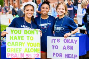 women's soccer team holding signs