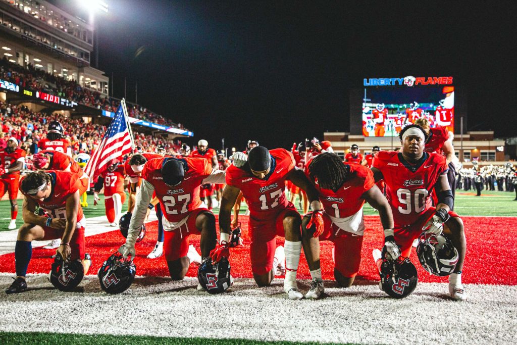 Flames take a knee in prayer before the game.