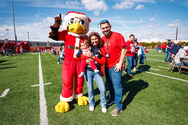 Fans posed with Sparky during the Alumni Tailgate. Photo by Matt Reynolds Liberty Marketing.