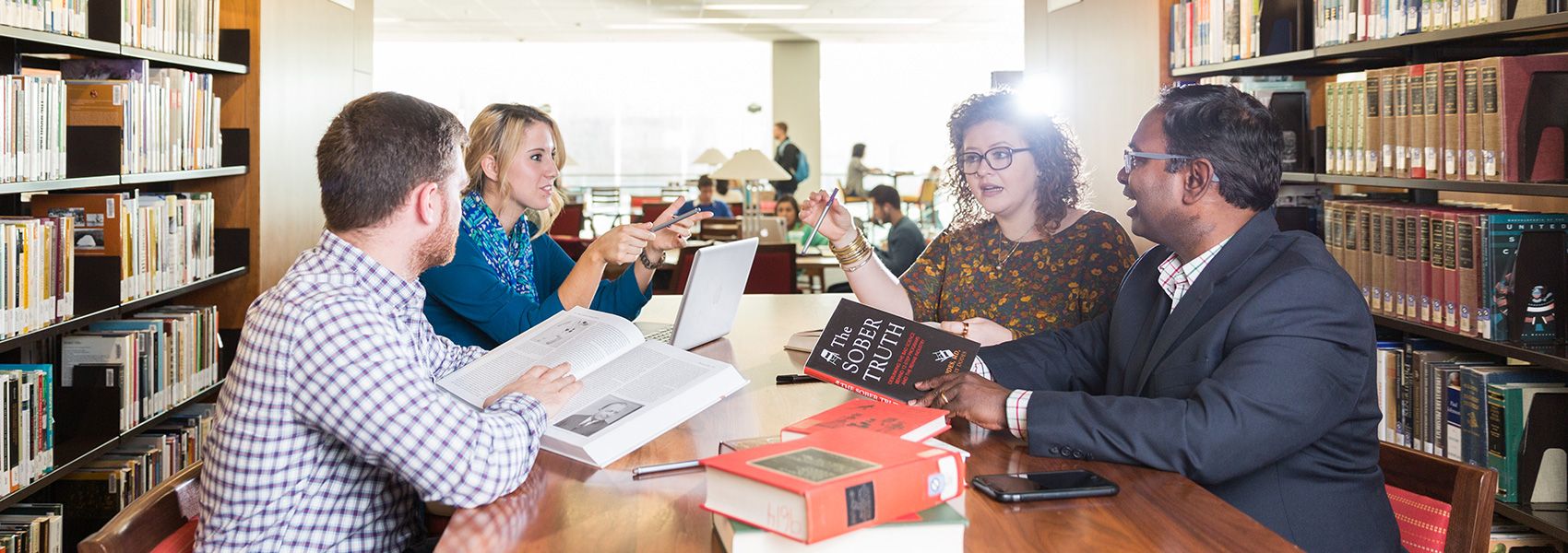 Students talking with Professors in the library