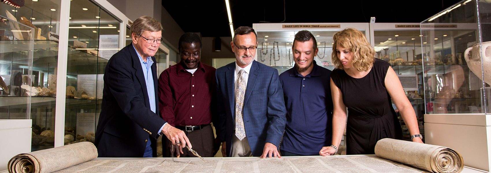 Biblical Studies faculty reading scroll