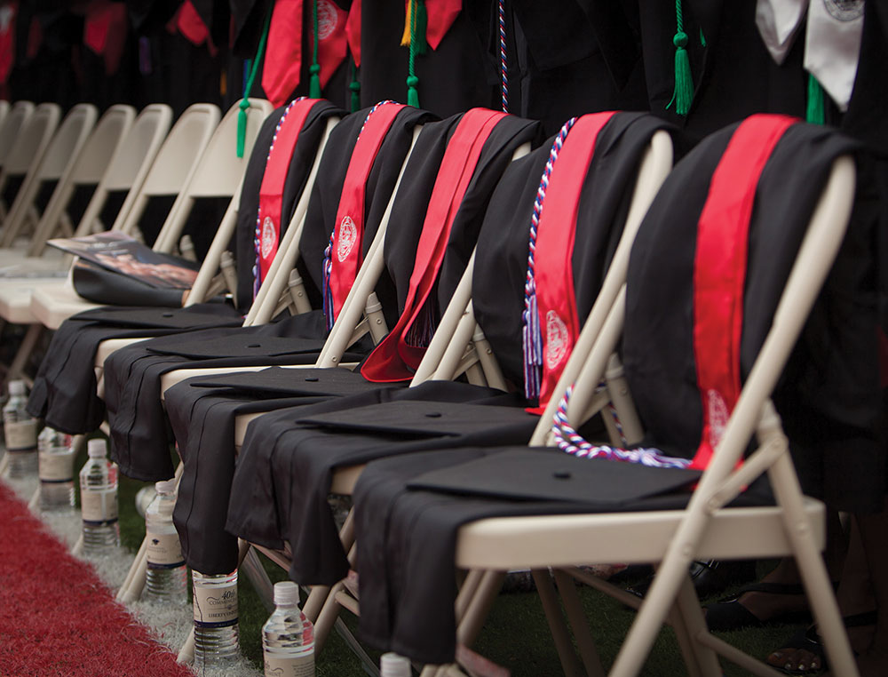 Five empty chairs were draped with the graduation regalia of five individuals who were honored for making the ultimate sacrifice for their country.