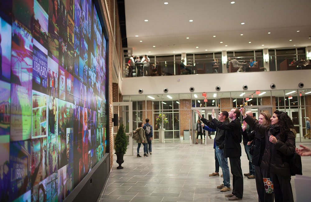 A 24-by-11-foot media wall equipped with Microsoft Kinect movement recognition technology is a favorite attraction for students in the new library.
