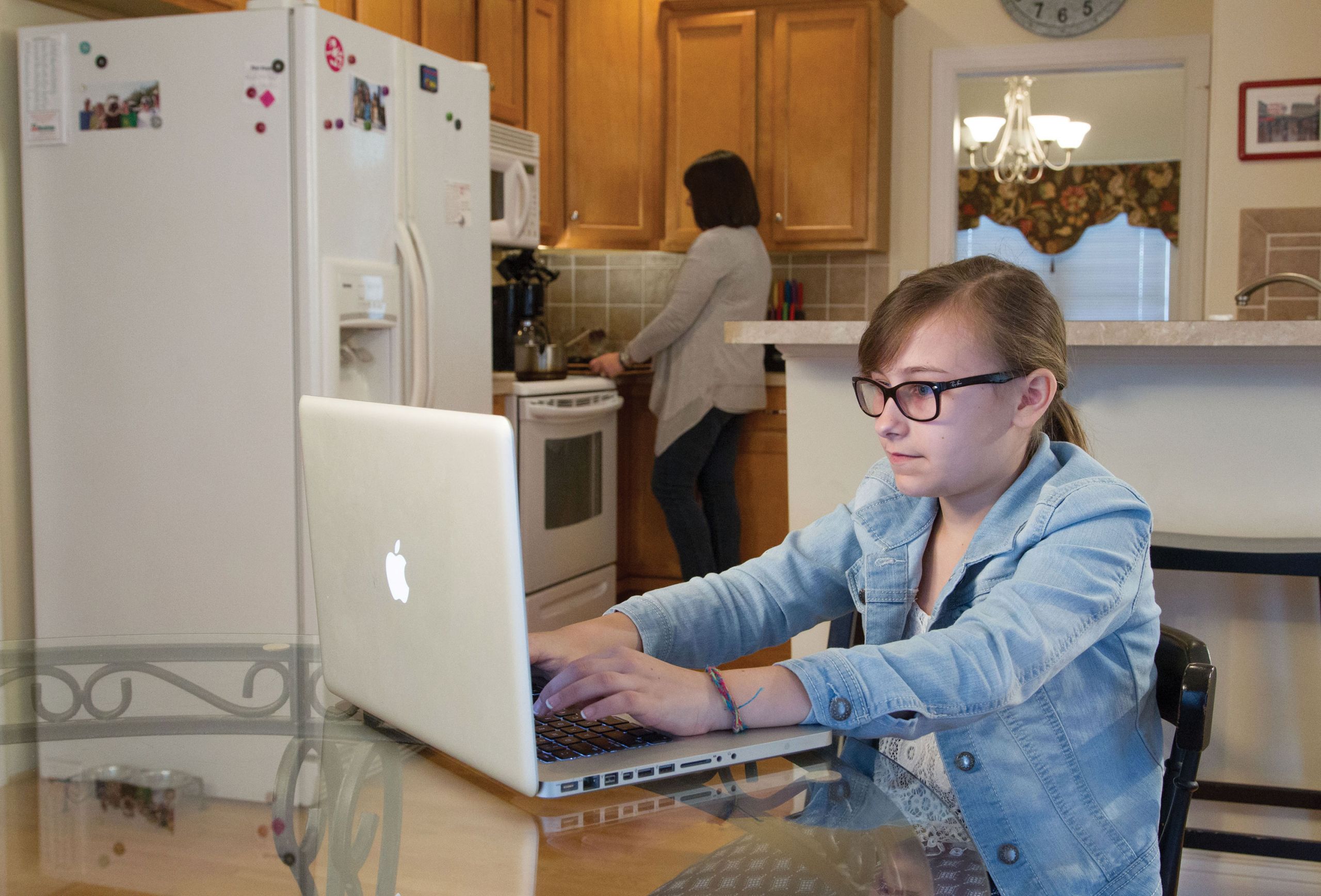 An LUOA student studies in their kitchen.