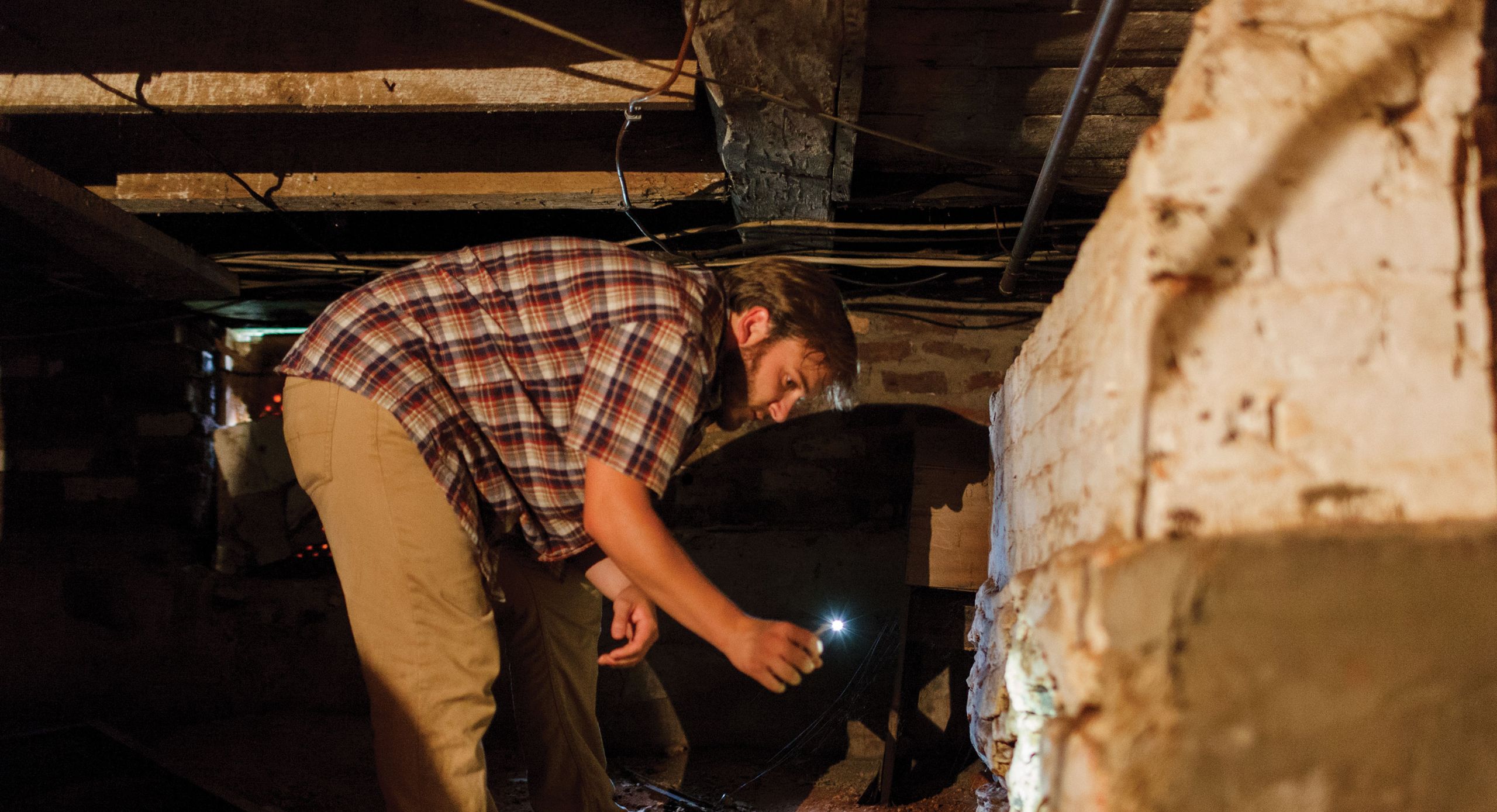 Ben Barker, a student in Liberty’s first public history course, explores the foundation of Mead’s Tavern, an 18th century building in Bedford County, Va., that the university recently purchased and plans to restore.