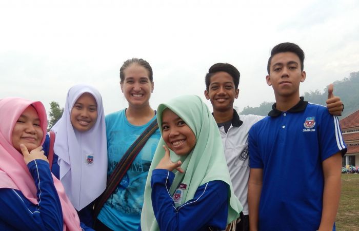 Cheryl Watson poses with some of the students she taught in Malaysia.
