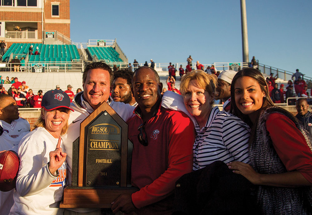 Liberty athletics leaders and their families celebrate a conference win.
