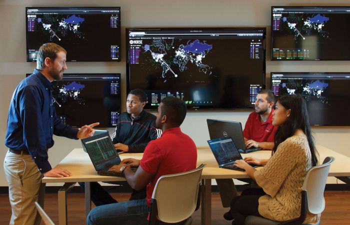 Dr. Mark Shaneck (left), online chair of cybersecurity, focuses on teaching students practical, hands-on skills.