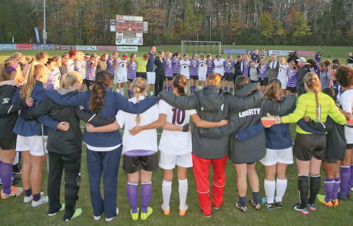 The Lady Flames join High Point players at the end of the Big South Championship game on Nov. 9.