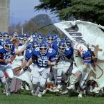 Members of the Liberty Baptist College Flames Football team take the field at Lynchburg Municipal Stadium in November 1979.