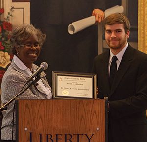 Sandrea Williamson, an ALD National Council member, presents ALD Chapter President Brian Mauldin a scholarship.