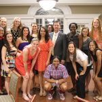 Chancellor Falwell celebrates with the Lady Flames basketball team during an awards banquet.